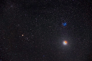 Lunar Eclipse Photography Prints: Partial eclipse of the moon below the Pleiades star cluster in Taurus
