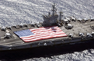 Personnel participate in a flag unfurling rehearsal on the flight deck aboard USS Nimitz Personnel participate in a flag unfurling rehearsal on the flight deck aboard USS Nimitz