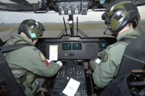 Pilots inside the cockpit of a Royal Air Force Merlin Helicopter at RAF Lyneham Pilots inside the cockpit of a Royal Air Force Merlin Helicopter at RAF Lyneham