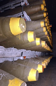 Racks of bombs sit inside the interior of a warehouse Racks of bombs sit inside the interior of a warehouse