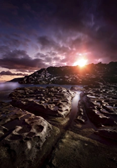 Rocky shore and tranquil sea against cloudy sky at sunset, Sardinia, Italy Rocky shore and tranquil sea against cloudy sky at sunset, Sardinia, Italy