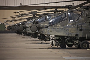 A row of AH-64D Apache helicopters at Pinal Airpark, Arizona A row of AH-64D Apache helicopters at Pinal Airpark, Arizona