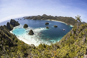 Rugged limestone islands surround a gorgeous lagoon in Raja Ampat Rugged limestone islands surround a gorgeous lagoon in Raja Ampat
