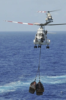 Two SA-330 Puma helicopters deliver pallets Two SA-330 Puma helicopters deliver pallets