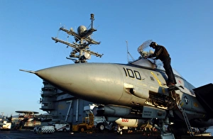 A Sailor cleans the canopy of an F-14D Tomcat A Sailor cleans the canopy of an F-14D Tomcat