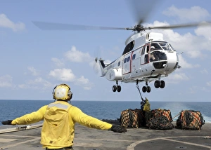 Sailors attempt to attach a cargo pennant to an SA-330J Puma helicopter aboard USS Denver Sailors attempt to attach a cargo pennant to an SA-330J Puma helicopter aboard USS Denver