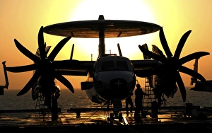 Sailors work on an E-2C Hawkeye aircraft aboard USS Abraham Lincoln Sailors work on an E-2C Hawkeye aircraft aboard USS Abraham Lincoln