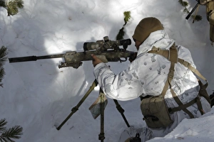 A scout sniper prepares his shot on target using a sniper rifle A scout sniper prepares his shot on target using a sniper rifle