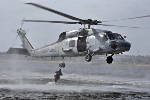 A search and rescue swimmer jumps from an SH-60F Sea Hawk helicopter A search and rescue swimmer jumps from an SH-60F Sea Hawk helicopter