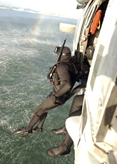A search and rescue swimmer student jumps from a MH-60S Knighthawk A search and rescue swimmer student jumps from a MH-60S Knighthawk