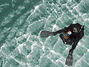 Search and Rescue swimmers are hoisted into an MH-60S Seahawk over the Persian Gulf Search and Rescue swimmers are hoisted into an MH-60S Seahawk over the Persian Gulf
