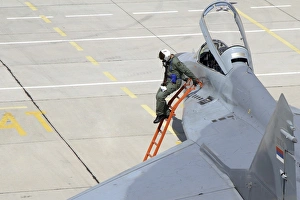 Serbian Air Force pilot climbs down from the cockpit of a MiG-29 Serbian Air Force pilot climbs down from the cockpit of a MiG-29