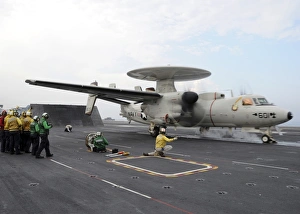 A shooter signals the launch of an E-2C Hawkeye aboard USS Abraham Lincoln A shooter signals the launch of an E-2C Hawkeye aboard USS Abraham Lincoln