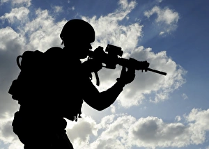 Silhouette of a soldier against a cloudy sky Silhouette of a soldier against a cloudy sky