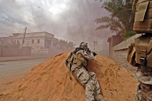A soldier lays down a vicious barrage of gun fire on insurgent positions A soldier lays down a vicious barrage of gun fire on insurgent positions