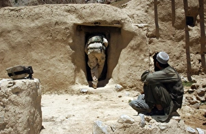A soldier from the National Guard searches the home of a suspected Taliban member A soldier from the National Guard searches the home of a suspected Taliban member