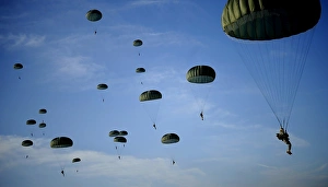 Soldiers descend under a parachute canopy during Operation Toy Drop Soldiers descend under a parachute canopy during Operation Toy Drop