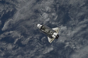 Space Shuttle Atlantis backdropped by a blue and white part of Earth Space Shuttle Atlantis backdropped by a blue and white part of Earth