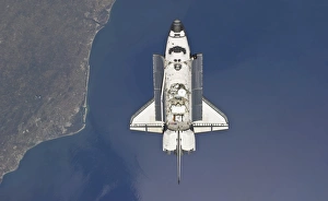 Space shuttle Atlantis backdropped by a colorful Earth, as the shuttle approaches Space shuttle Atlantis backdropped by a colorful Earth, as the shuttle approaches