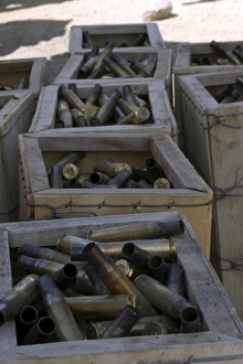 Spent .50-caliber machine gun shell casings sit inside wooden boxes Spent .50-caliber machine gun shell casings sit inside wooden boxes