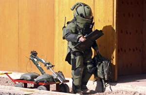 A technician from a Navy Explosive Ordnance Disposal Mobile Unit holding equipment A technician from a Navy Explosive Ordnance Disposal Mobile Unit holding equipment