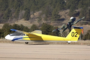 A TG-10B glider lifts into the air as it is towed down the runway A TG-10B glider lifts into the air as it is towed down the runway