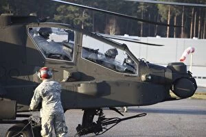 Ah 64 Collection: U. S. Army AH-64D Apache helicopter pilots conduct preflight checks