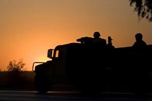 Images Dated 5th October 2005: A U. S. Army Humvee with soldiers in the back at sunset