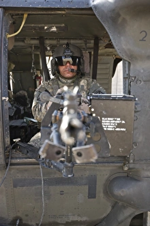 A UH-60 Black Hawk door gunner manning a M240B machine gun A UH-60 Black Hawk door gunner manning a M240B machine gun