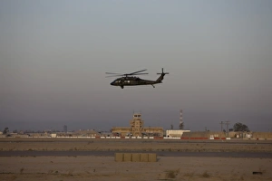 A UH-60 Blackhawk helicopter flies past the tower on Camp Speicher A UH-60 Blackhawk helicopter flies past the tower on Camp Speicher