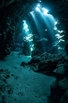 Egyptian Rock Formations Prints: An underwater cavern has a path that is lit from above