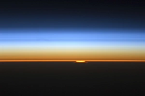 View of the sun peeking over the limb of the Earth View of the sun peeking over the limb of the Earth