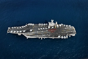 Weapons department personnel on the flight deck of the aircraft carrier USS John C Weapons department personnel on the flight deck of the aircraft carrier USS John C