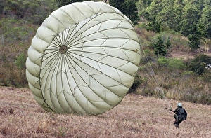 The wind pushes a Honduran soldiers chute after he lands safely The wind pushes a Honduran soldiers chute after he lands safely