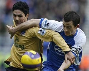 Wigan Athletics Baines challenges Evertons Arteta for the ball during their English Premier League Wigan Athletics Baines challenges Evertons Arteta for the ball during their English Premier League