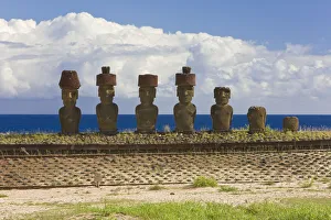 Anakena beach, monolithic giant stone Moai statues of Ahu Nau Nau, four of which have topknots Anakena beach, monolithic giant stone Moai statues of Ahu Nau Nau, four of which have topknots