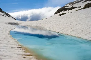 Blue ice melt pool in snow near the peak of La Munia Circo. The Pyrenees, Aragon Blue ice melt pool in snow near the peak of La Munia Circo. The Pyrenees, Aragon
