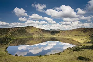 Crater lake with reflections of clouds in the water, Queen Elizabeth National Park Crater lake with reflections of clouds in the water, Queen Elizabeth National Park