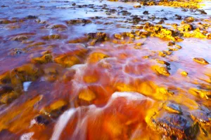 Red waters of the Rio Tinto, coloured by dissolved minerals, primarily iron. Andalusia Red waters of the Rio Tinto, coloured by dissolved minerals, primarily iron. Andalusia