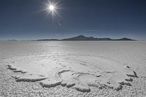 RF- Landscape of salt pan with sun high above, Salar de Uyuni, Altiplano, Bolivia RF- Landscape of salt pan with sun high above, Salar de Uyuni, Altiplano, Bolivia