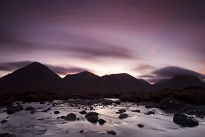 Silhouettes of the Red Cullin at dawn, with stream in the foreground, Isle of Skye Silhouettes of the Red Cullin at dawn, with stream in the foreground, Isle of Skye