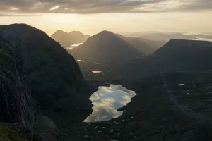Sunset over Loch Coire Mhic Fhearchair from Beinn Eighe with the sky reflected in the Sunset over Loch Coire Mhic Fhearchair from Beinn Eighe with the sky reflected in the