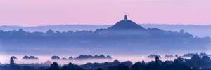 View towards Glastonbury Tor with low lying mist at dawn from Waltons Hill, Glastonbury View towards Glastonbury Tor with low lying mist at dawn from Waltons Hill, Glastonbury