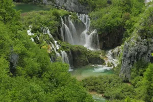 Waterfall and rapids falling into a mountain pool in woodland. Plitvice National Park Waterfall and rapids falling into a mountain pool in woodland. Plitvice National Park