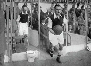 Arsenal FC captain Eddie Hapgood runs onto the pitch at Highbury, London, 1930s. Artist: Barratts Photo Press Ltd Arsenal FC captain Eddie Hapgood runs onto the pitch at Highbury, London, 1930s. Artist: Barratts Photo Press Ltd