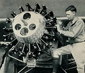 American Aviator Portrait Prints: Charles Lindbergh checking the engine of his aircraft before his transatlantic flight