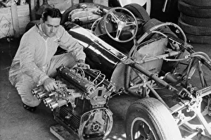 Vintage Motor Sport Prints: Jack Brabham inspecting the engine of a car