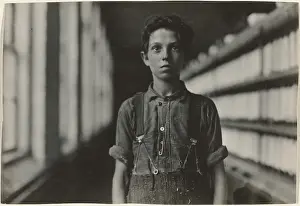 Prints of Jo Bodeon, a back-roper in mule room. Chase Cotton Mill, Burlington, Vermont, 1909. Additional Info: Portrait of a boy standing in a factory, wearing overalls Lewis Wickes Hine Prints: Jo Bodeon Back-Roper Print, 1909