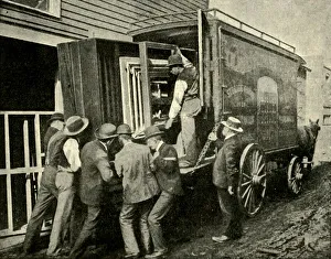 Historic Transportation Methods Prints: Loading The Camera On A Van For Removal, 1901. Creator: Unknown