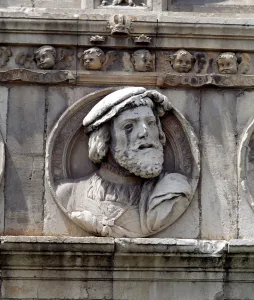 Medallion in stone on the facade of the old Hospital of San Marcos representing King Medallion in stone on the facade of the old Hospital of San Marcos representing King